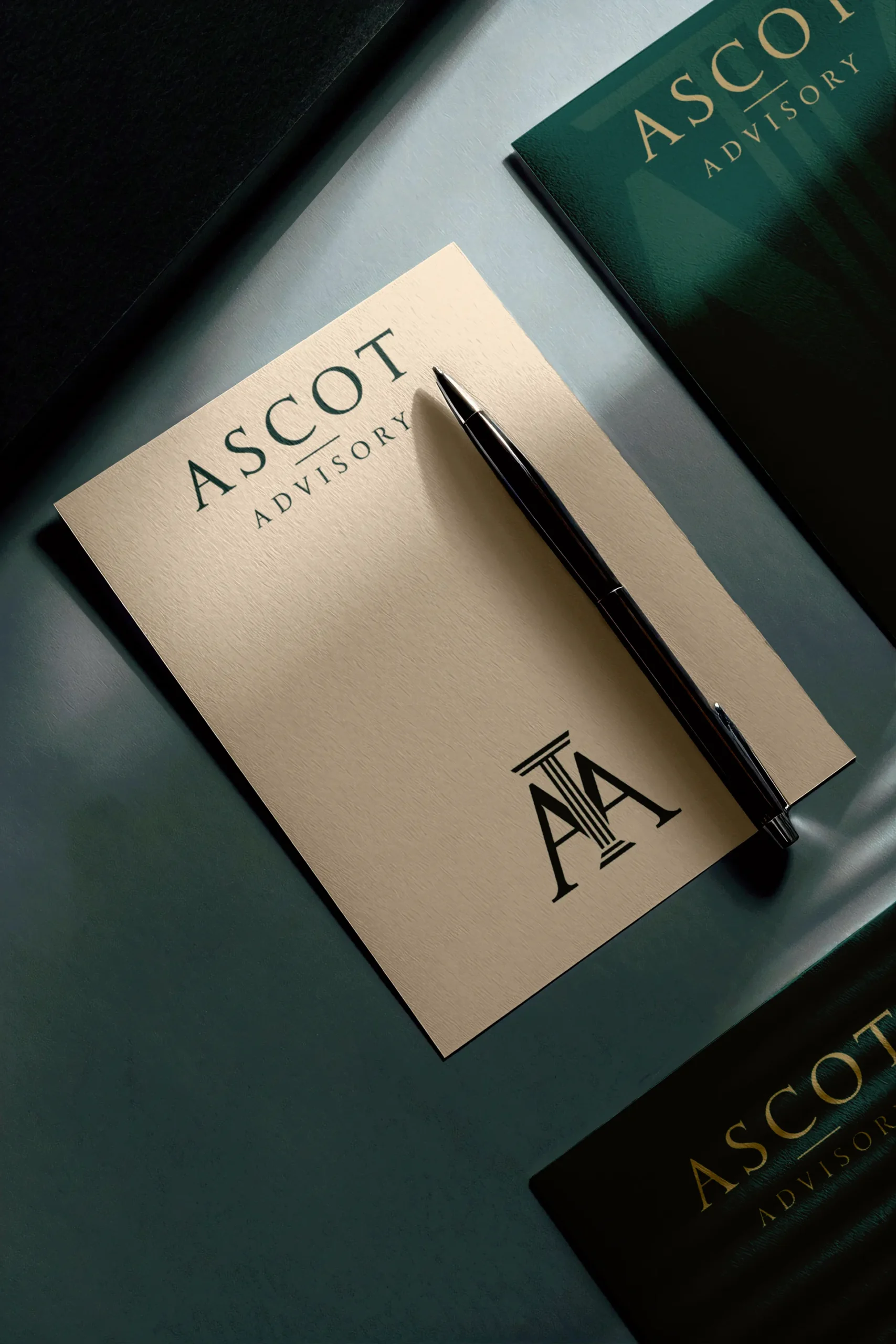 Branded Ascot Advisory notepad with luxury pen on a dark green surface, representing personalized tax and financial advisory services.